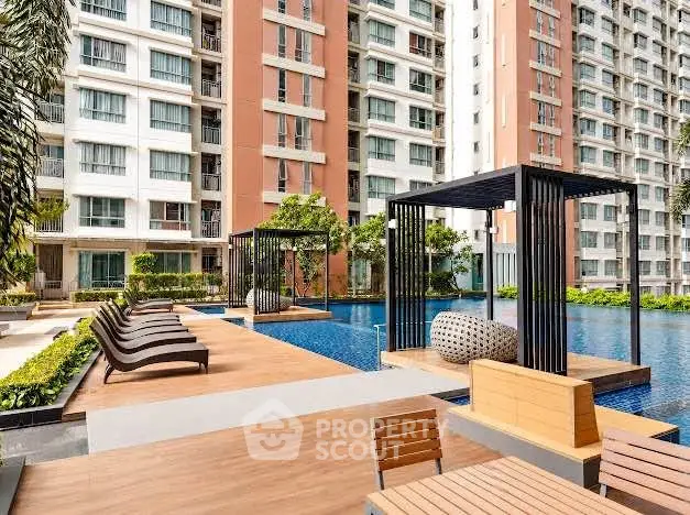 Luxurious apartment complex with modern poolside amenities and lush greenery.