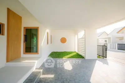 Modern house entrance with minimalist design and spacious outdoor area