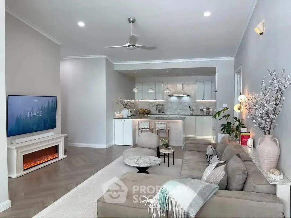 Modern open-plan living room with cozy fireplace and stylish kitchen