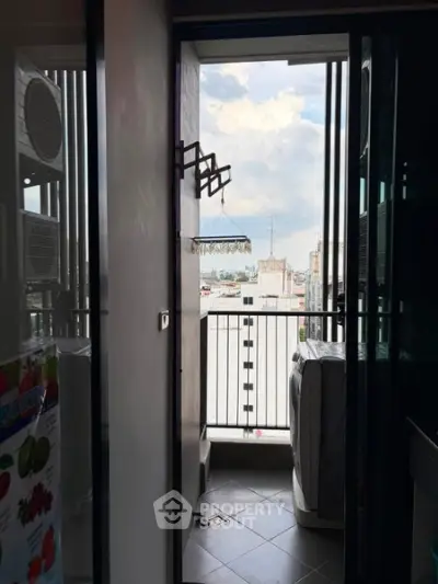 Charming balcony with city view and laundry area in modern apartment.
