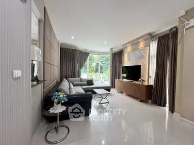 Spacious modern living room with large windows and elegant decor
