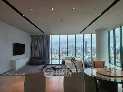 Luxurious modern living room with panoramic city views and elegant furnishings.