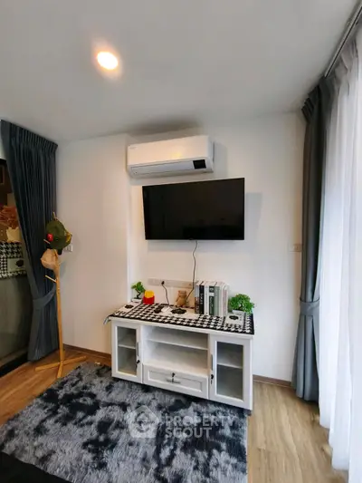 Modern living room with wall-mounted TV and air conditioning unit