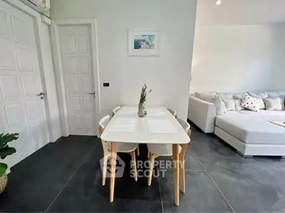 Modern living room with stylish dining area and cozy sofa, perfect for relaxation and entertaining.