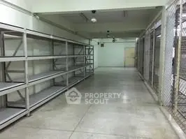 Spacious storage area with metal shelving and secure fencing