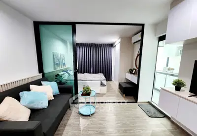 Modern apartment interior with cozy living room and stylish bedroom separated by glass wall.