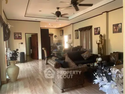 Spacious living room with elegant decor and wicker furniture, perfect for relaxation and entertaining.