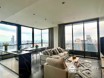 Luxurious modern living room with panoramic city views and sleek open kitchen design.