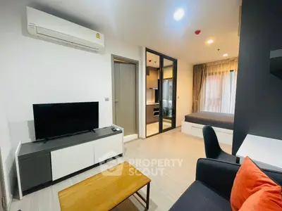 Modern studio apartment with open layout, featuring a cozy living area and sleek kitchen design.