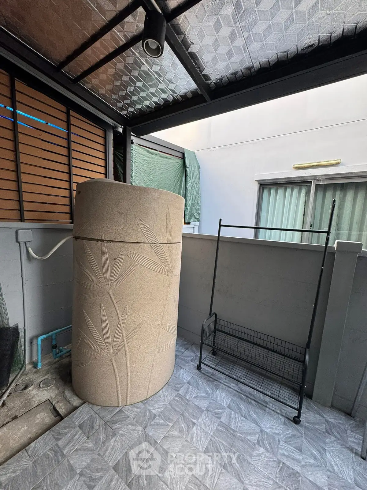 Modern outdoor space with stylish water tank and tiled flooring