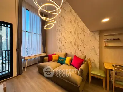 Modern living room with stylish lighting and cozy seating in a high-rise apartment.