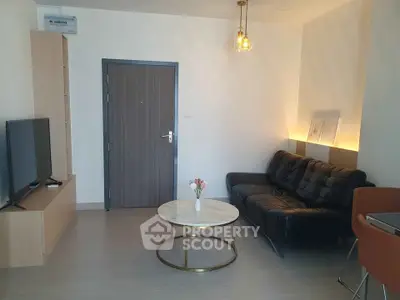 Modern living room with sleek black sofa and stylish coffee table