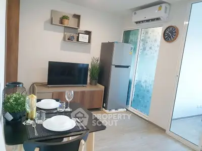 Modern living room with dining area, TV, and air conditioning in a stylish apartment.