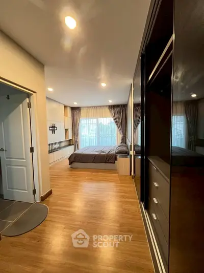 Spacious bedroom with modern design and large windows for natural light.