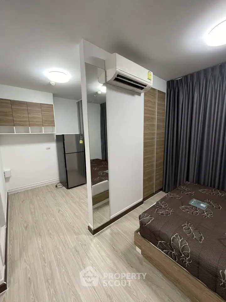 Modern bedroom with air conditioning and stylish decor in a cozy apartment.