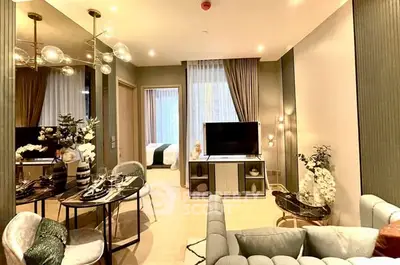 Luxurious modern living room with elegant decor and open view into a cozy bedroom.