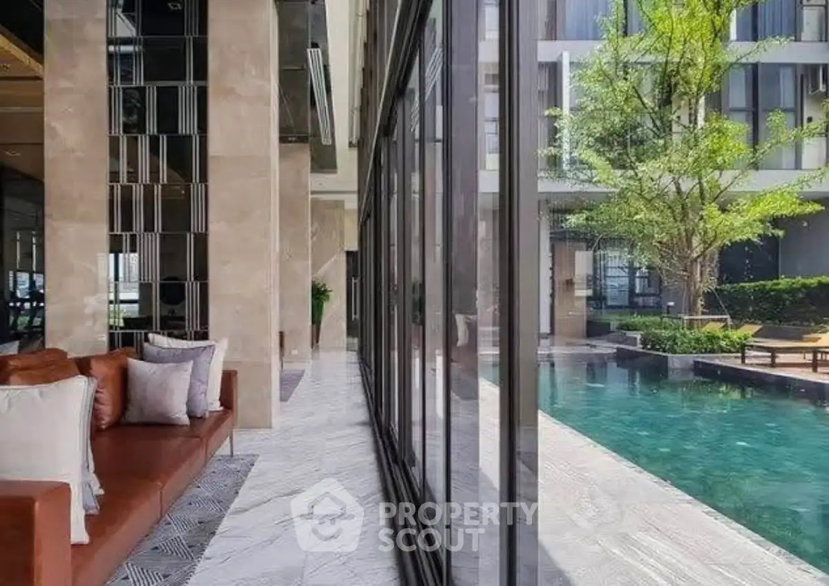 Luxurious modern living space with poolside view and elegant design.