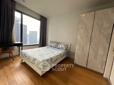 Modern bedroom with large window and stylish wardrobe in urban apartment