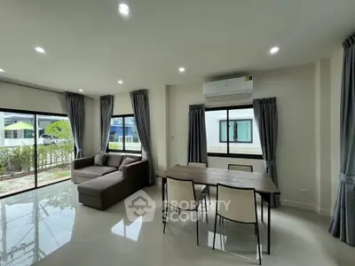 Spacious modern living room with large windows and stylish furniture