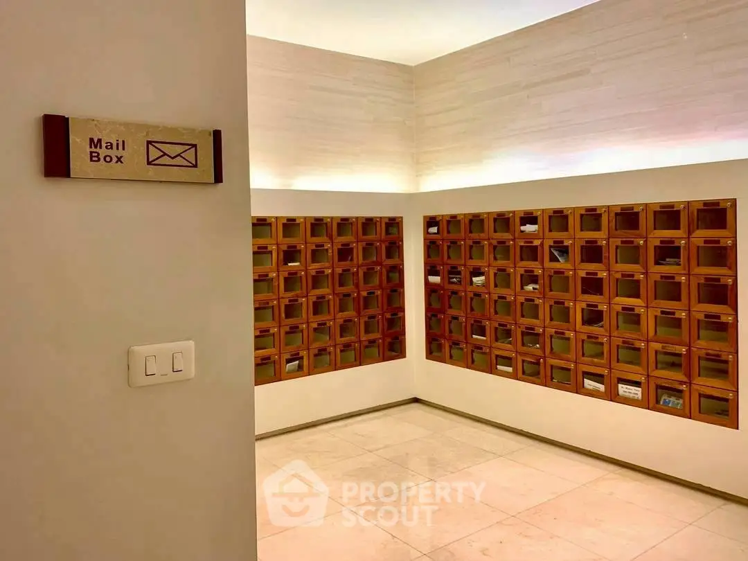 Modern apartment building mailroom with organized mailboxes and sleek design.