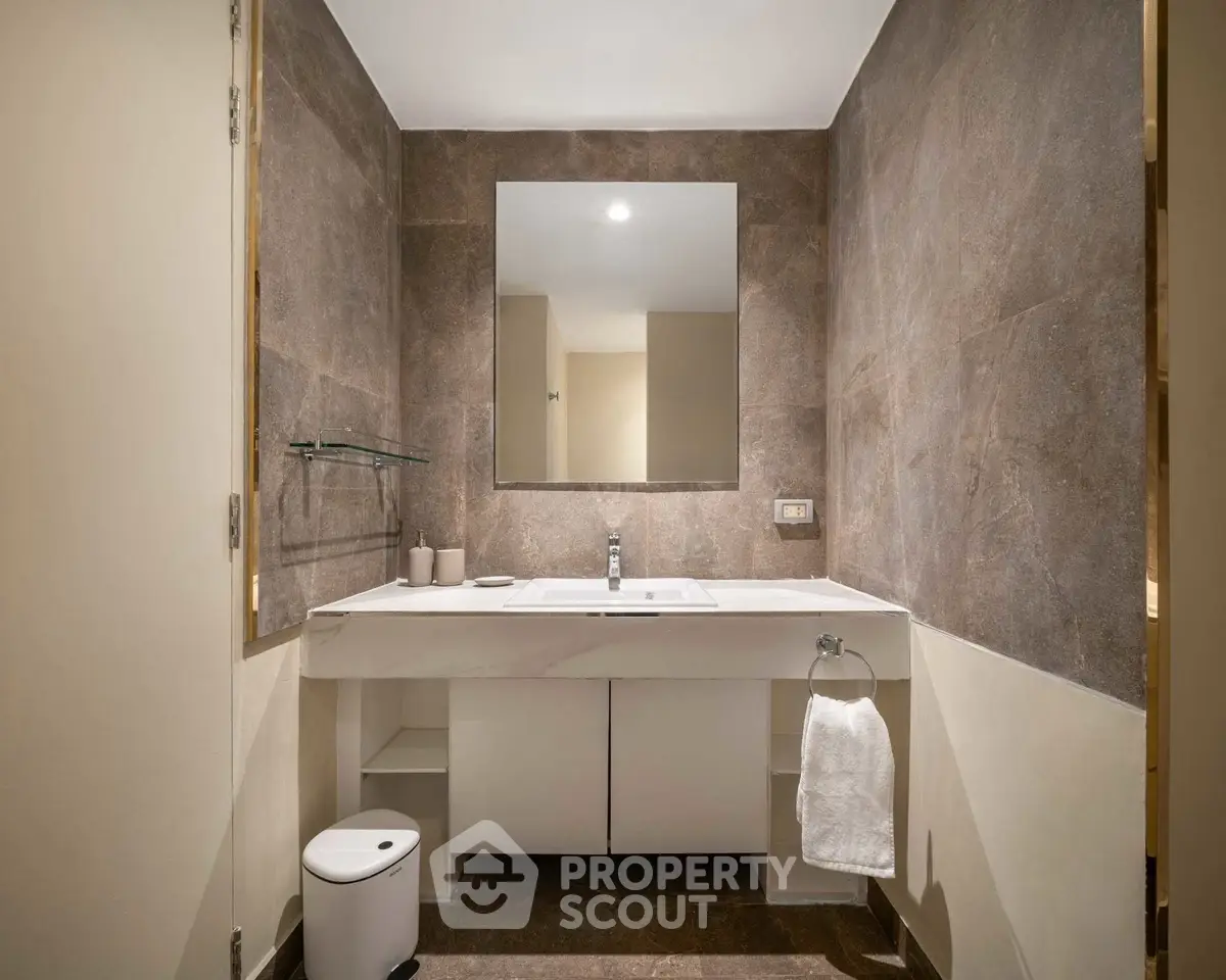 Modern bathroom with elegant marble sink and large mirror