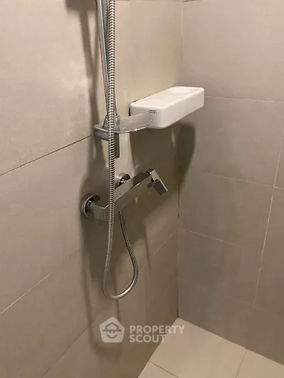 Modern bathroom shower with sleek fixtures and neutral tiles