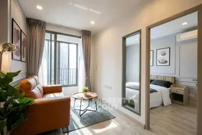 Modern apartment living room with cozy leather sofa and bedroom view