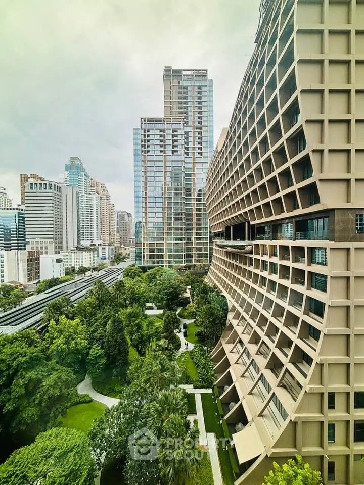 Stunning urban view of modern high-rise buildings with lush green gardens in a vibrant cityscape.