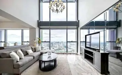 Luxurious high-rise living room with panoramic city views and elegant decor.