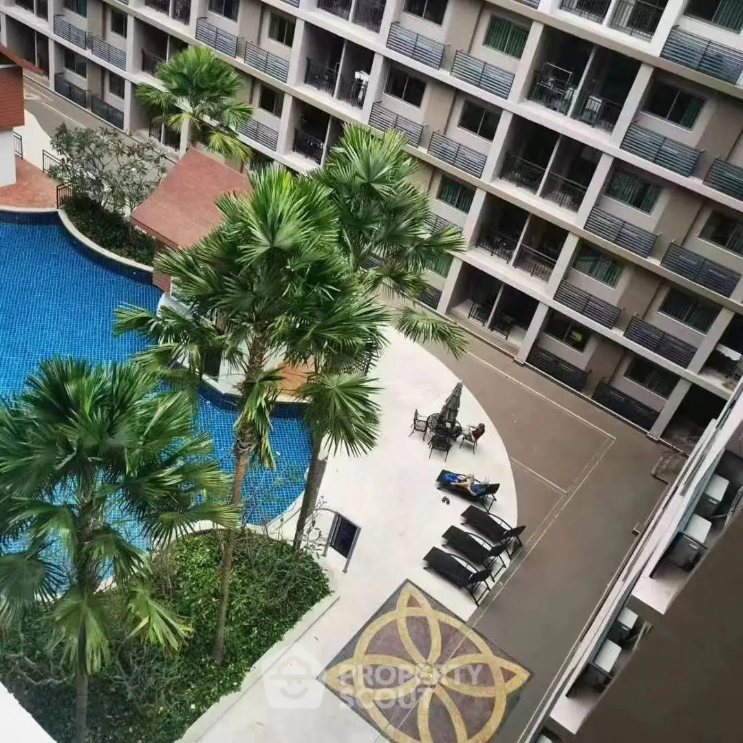 Luxurious apartment complex with pool and palm trees offering resort-style living.