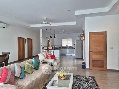 Spacious open-plan living room with modern kitchen and stylish decor