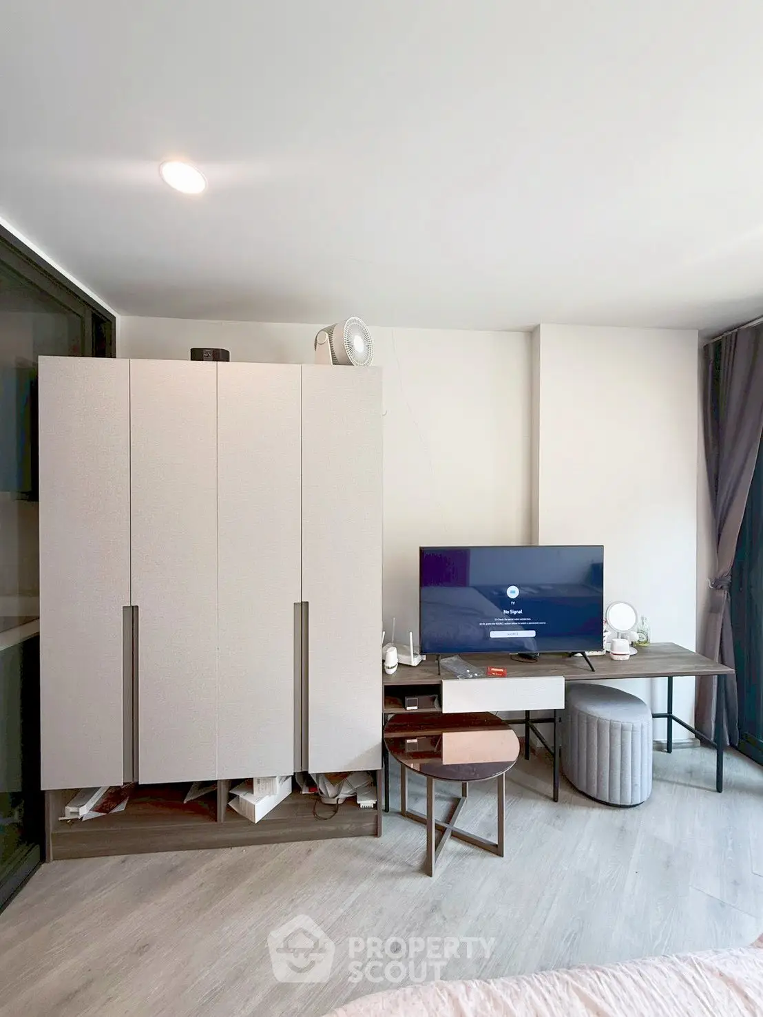 Modern living room with sleek furniture and entertainment setup in a stylish apartment.