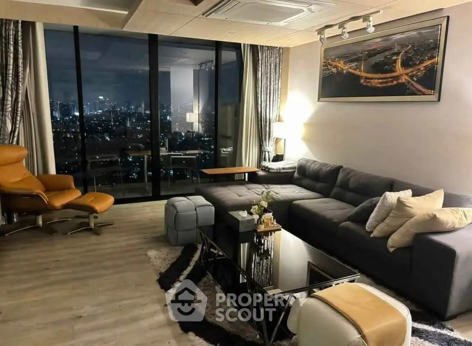 Luxurious living room with city view, modern furniture, and elegant decor in high-rise apartment.