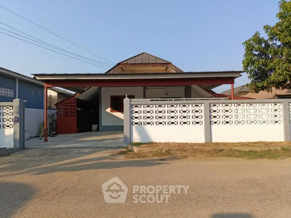 Charming single-story home with spacious driveway and decorative fence