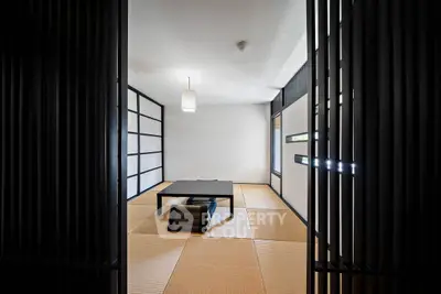 Minimalist Japanese-style room with tatami mats and low table, perfect for serene living.