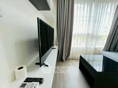 Modern living room with sleek TV setup and floor-to-ceiling windows