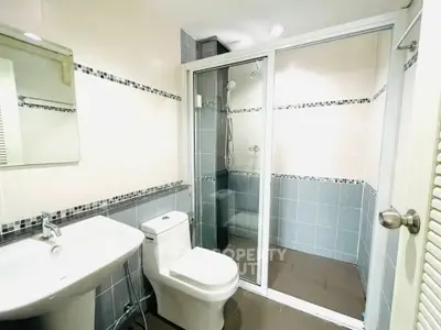 Modern bathroom with glass shower enclosure and sleek fixtures