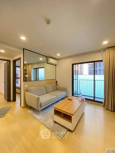 Modern living room with cozy sofa and large window in stylish apartment