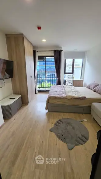 Modern bedroom with balcony access and stylish decor in urban apartment