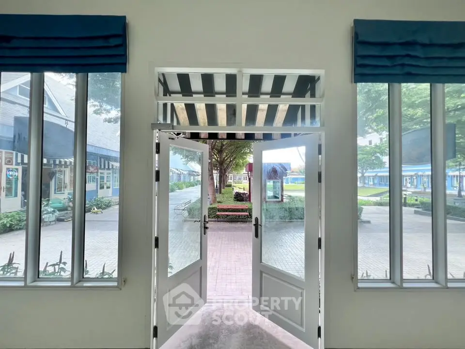 Inviting entrance with large windows and outdoor view, perfect for welcoming guests.