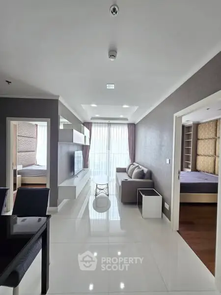 Modern apartment interior with sleek design and natural light, featuring a cozy living room and stylish decor.