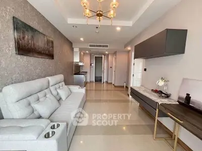 Modern living room with elegant decor and spacious layout, featuring a stylish chandelier and comfortable seating.