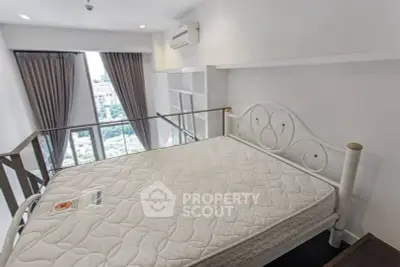 Modern bedroom with large window and stylish metal bed frame.