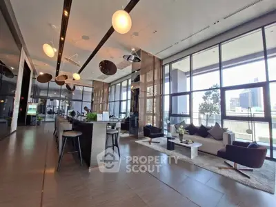Spacious modern living room with large windows and stylish decor in a luxury apartment.