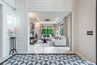 Luxurious living room with elegant decor and large windows offering garden views.