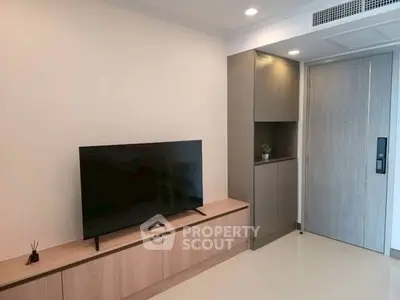 Modern living room with sleek TV setup and stylish cabinetry