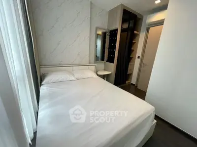 Modern bedroom with sleek design, featuring a comfortable bed and built-in wardrobe for optimal storage.