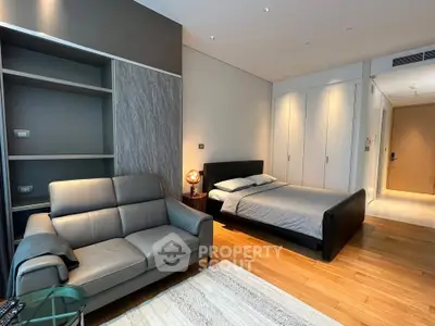 Modern bedroom with sleek design, featuring a cozy bed, stylish sofa, and built-in storage in a luxurious apartment.