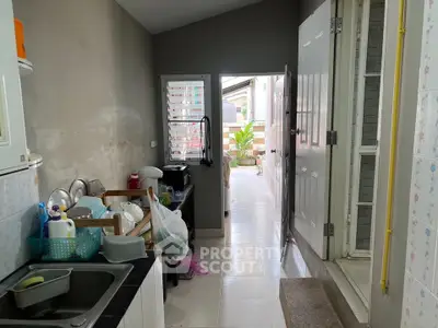 Cozy kitchen with open layout leading to a sunlit balcony, perfect for morning coffee.