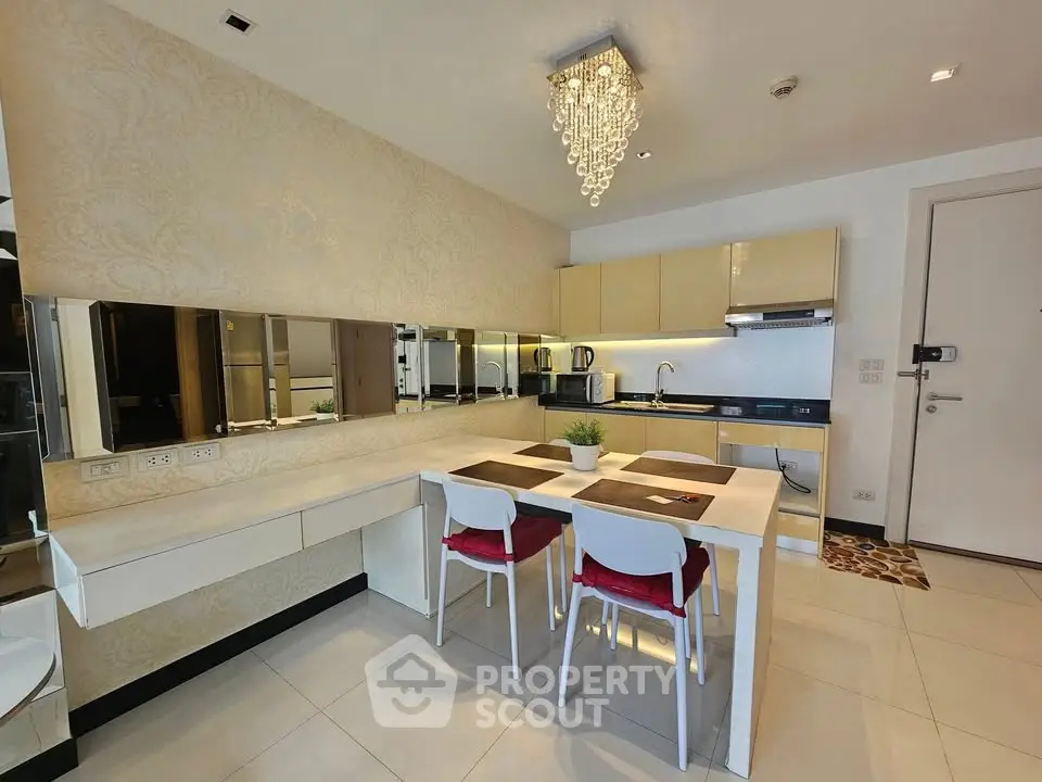 Modern kitchen with elegant dining area and chandelier lighting